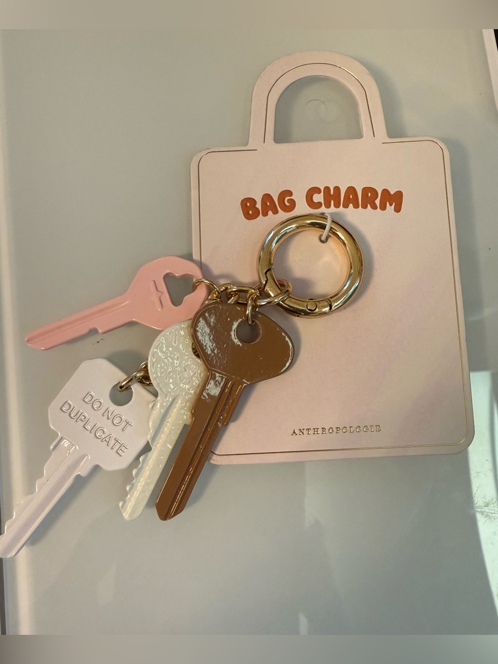 NWT Anthropologie Pink, White, and Tan Enamel Keyring Bag Charm!